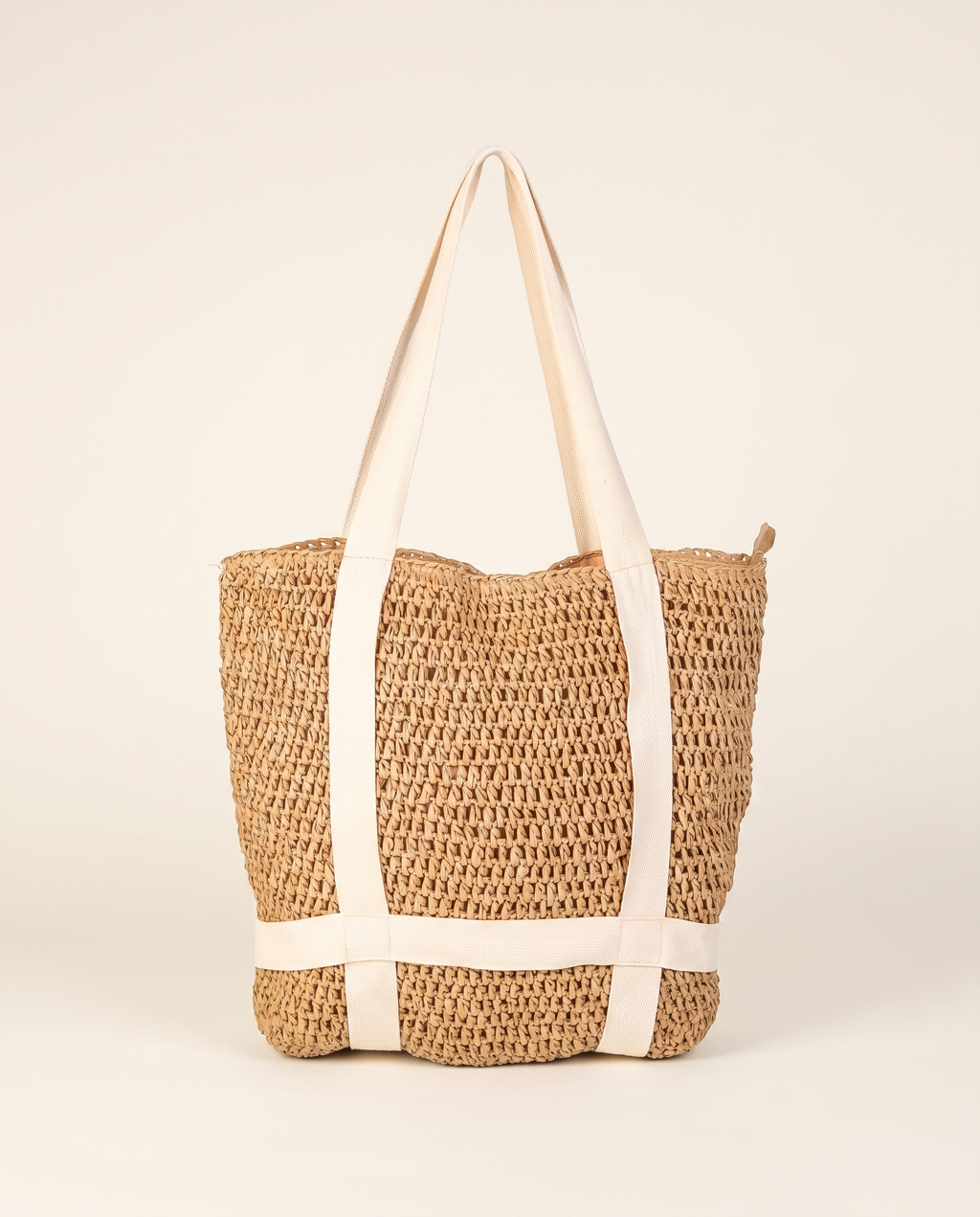 Braided Straw Beach Tote on a warm ivory studio background