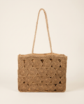 Circle-Braided Straw Tote on a warm ivory studio background