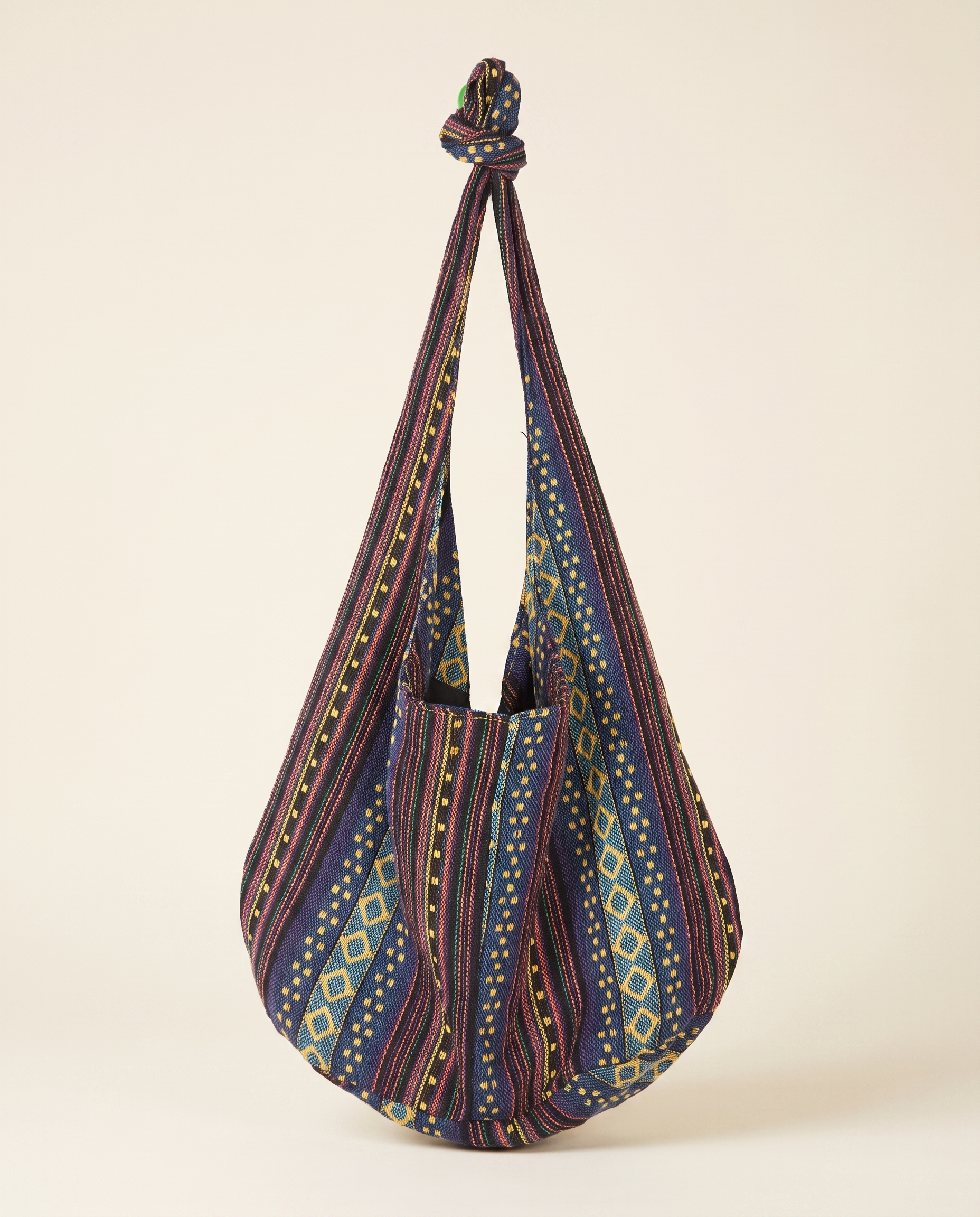 Woven Boho Shoulder Bag on a warm ivory studio background
