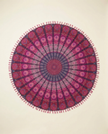 Round pink mandala boho beach towel flat-lay on warm ivory