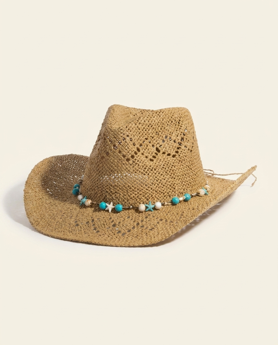 Natural straw sun hat with turquoise-and-shell beaded band on warm ivory