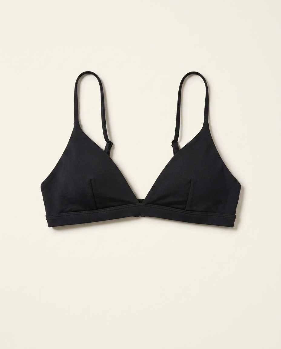 Black triangle bralette bikini top on warm ivory