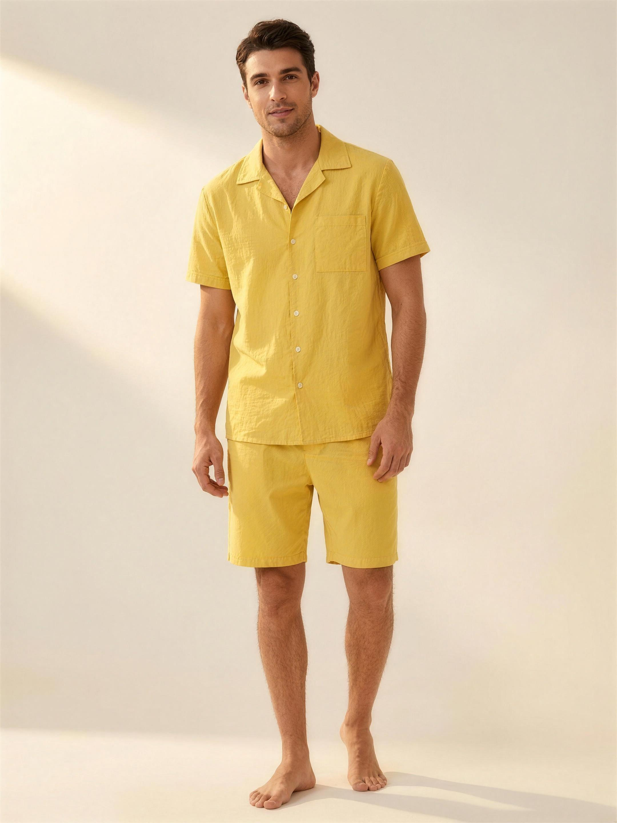 Men's yellow cotton shirt and shorts set on model, warm ivory studio